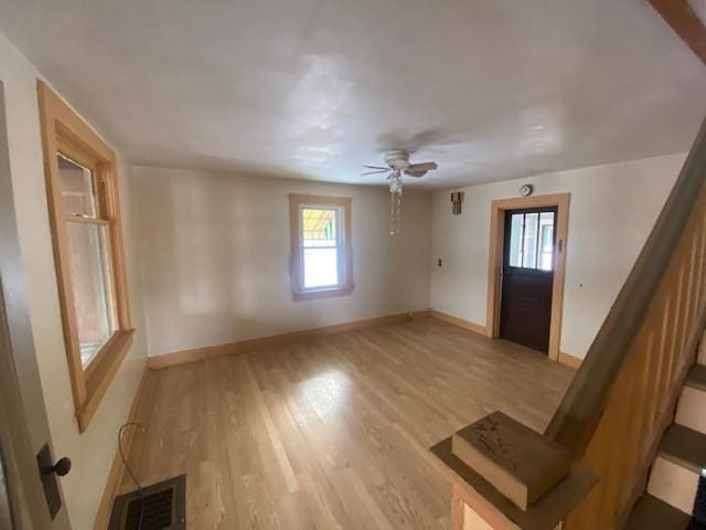 foyer with ceiling fan and light hardwood / wood-style flooring