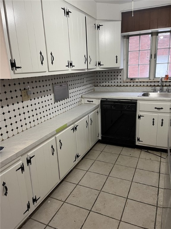 kitchen featuring tasteful backsplash, white cabinetry, dishwasher, and sink