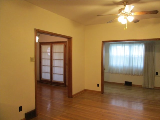 spare room featuring ceiling fan and hardwood / wood-style floors