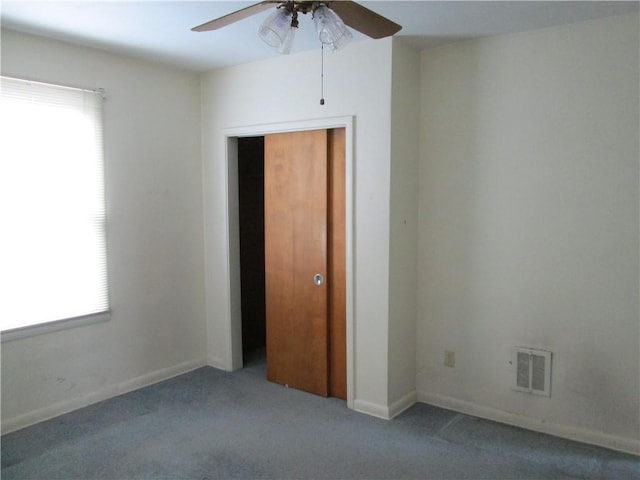 spare room featuring carpet and ceiling fan