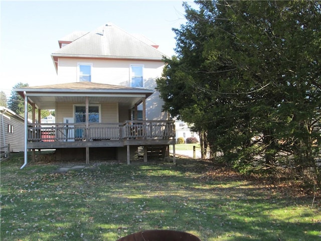 rear view of house with a yard and a deck