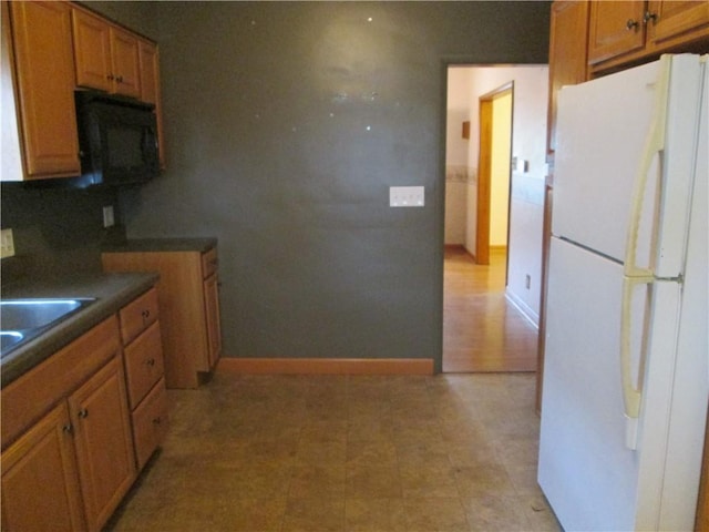 kitchen featuring tasteful backsplash, sink, and white fridge