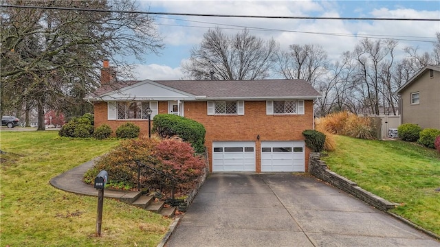 view of front of home with a front yard and a garage