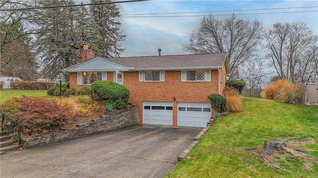 view of front of house with a garage and a front lawn