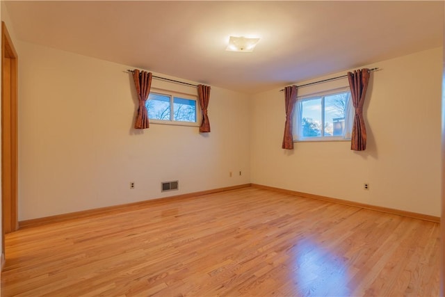 empty room featuring light hardwood / wood-style flooring and a wealth of natural light