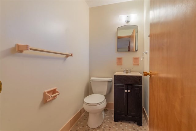 bathroom featuring tile patterned flooring, vanity, and toilet