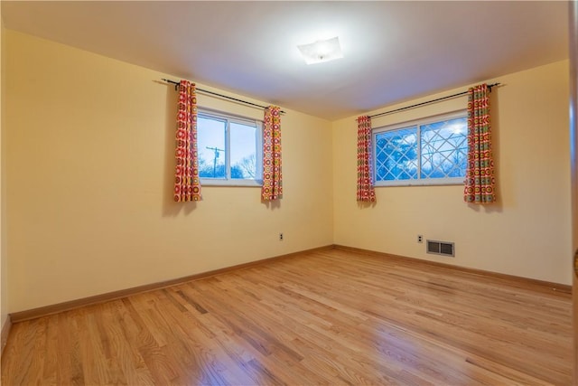 unfurnished room with wood-type flooring