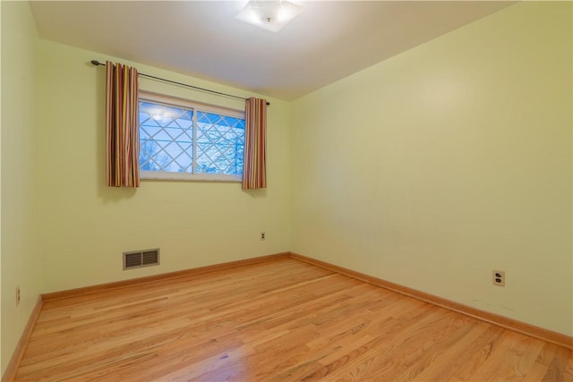 spare room featuring light wood-type flooring