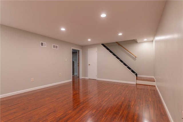 basement with dark hardwood / wood-style floors