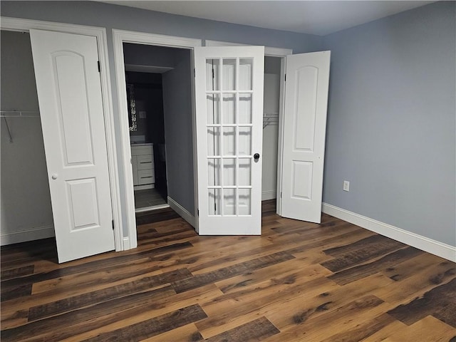 unfurnished bedroom with dark hardwood / wood-style floors and a closet