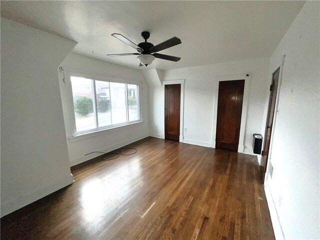 unfurnished bedroom featuring ceiling fan and dark wood-type flooring