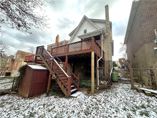 snow covered property featuring a deck