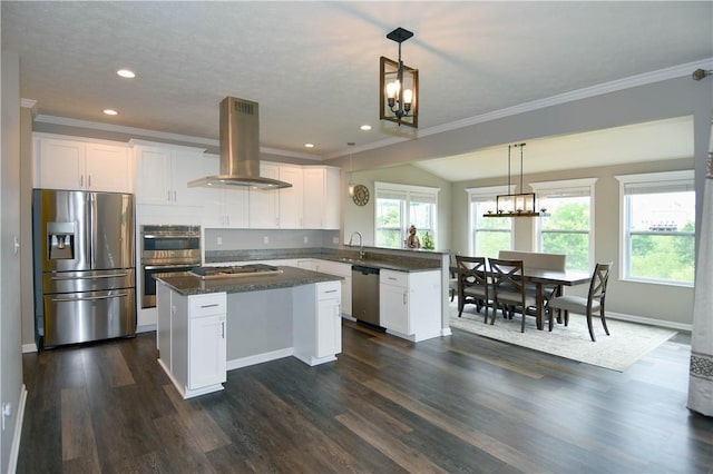 kitchen featuring white cabinets, hanging light fixtures, appliances with stainless steel finishes, a kitchen island, and island exhaust hood