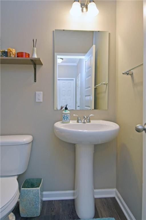 bathroom featuring hardwood / wood-style floors, toilet, and sink