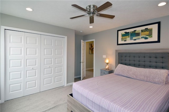 bedroom featuring light carpet, a closet, and ceiling fan