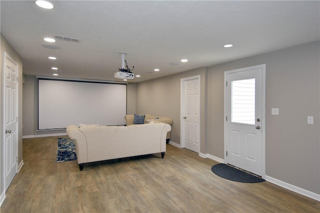 cinema room with light hardwood / wood-style floors