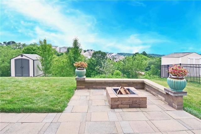 view of patio / terrace with a shed and an outdoor fire pit