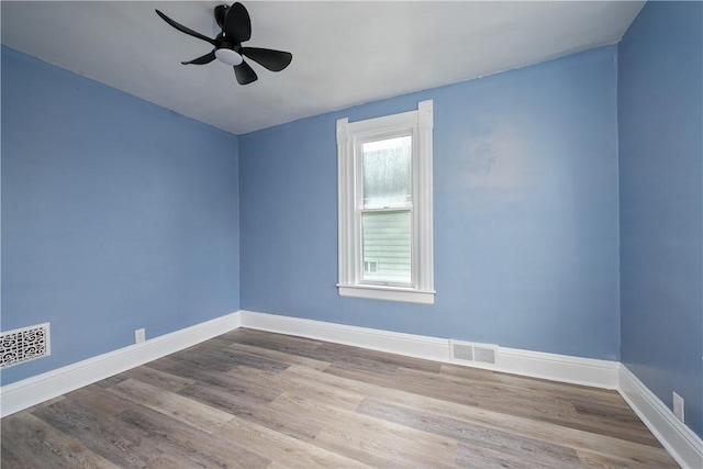 spare room featuring ceiling fan and light hardwood / wood-style flooring