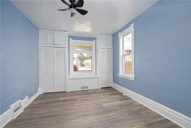 unfurnished room with hardwood / wood-style flooring and ceiling fan