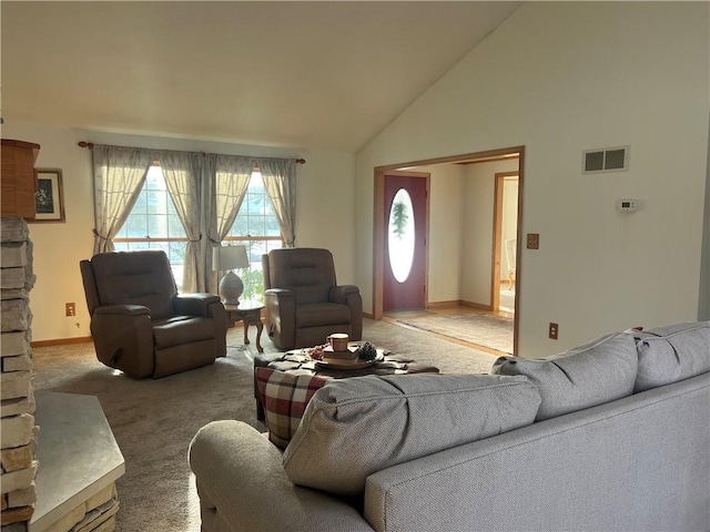 living area with baseboards, high vaulted ceiling, visible vents, and light carpet