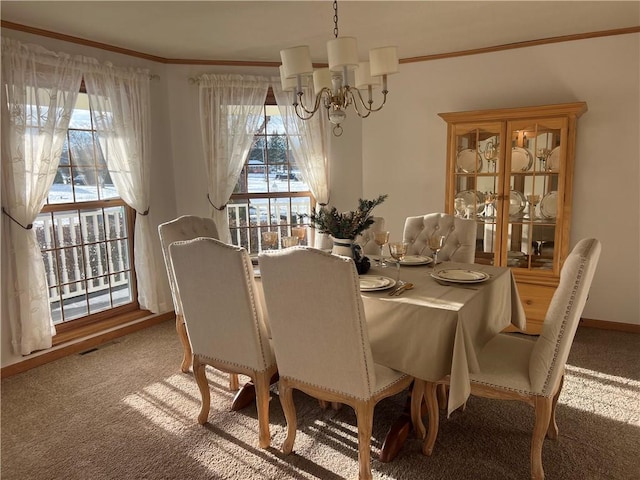 carpeted dining space with ornamental molding, an inviting chandelier, and a wealth of natural light