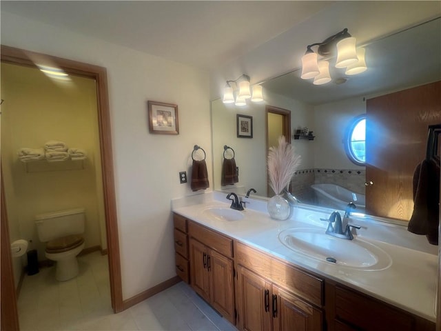 bathroom featuring a washtub, tile patterned floors, vanity, and toilet