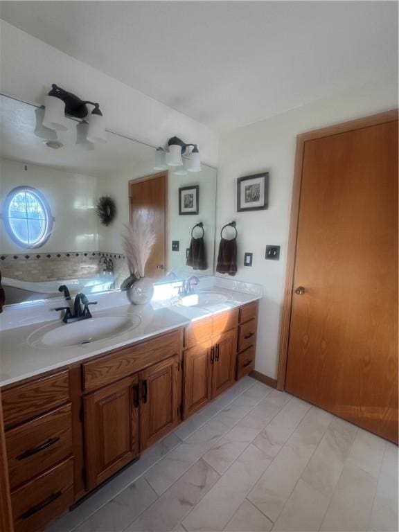bathroom with double vanity, a sink, and marble finish floor