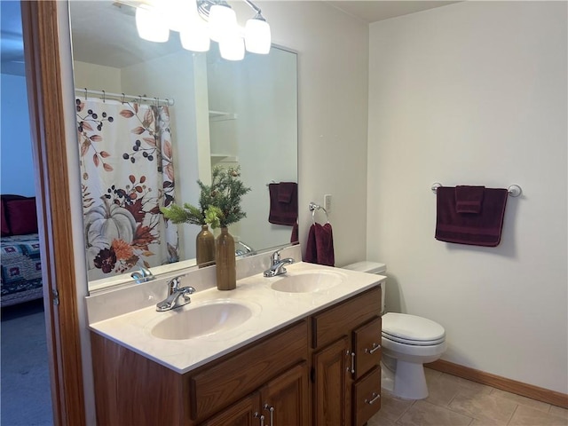 bathroom with toilet, a sink, double vanity, and tile patterned floors