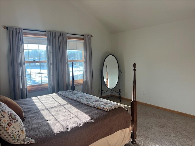 carpeted bedroom featuring lofted ceiling