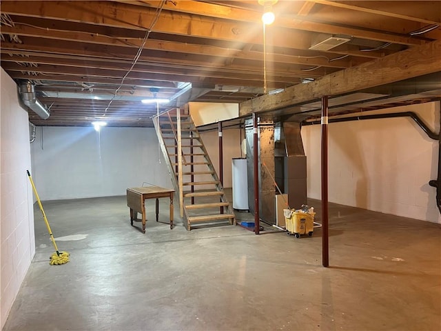 unfinished below grade area featuring water heater, stairs, and heating unit