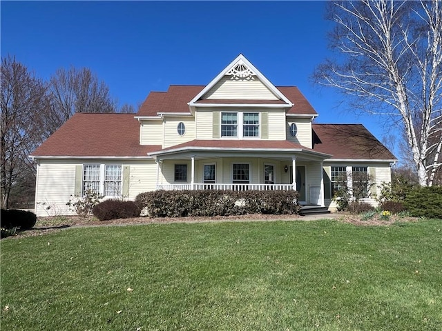 victorian home with covered porch and a front yard