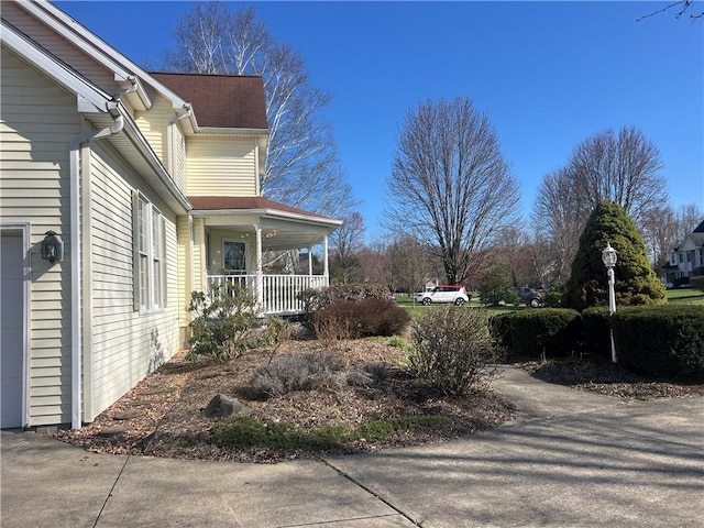 view of property exterior with a porch