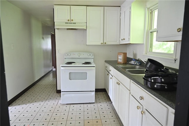 kitchen featuring electric stove, sink, and white cabinets