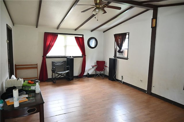 interior space featuring hardwood / wood-style floors, vaulted ceiling with beams, and ceiling fan