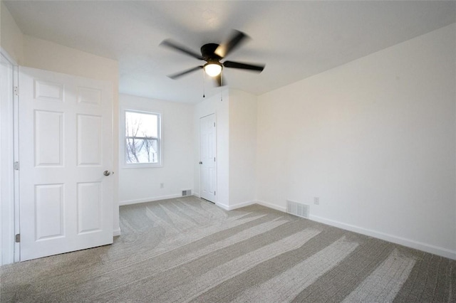 unfurnished bedroom with ceiling fan and light carpet