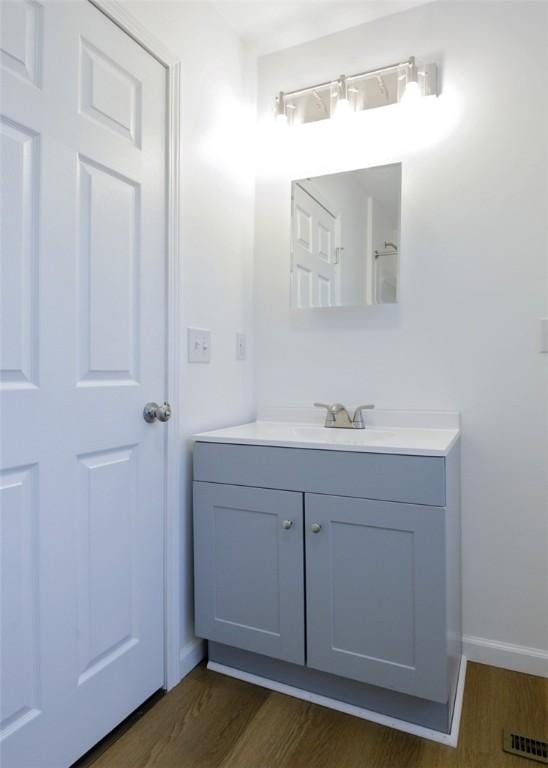 bathroom featuring hardwood / wood-style flooring and vanity