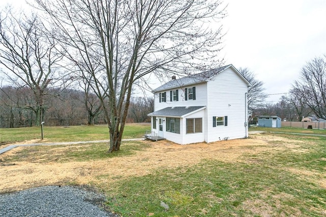 view of side of home with a yard