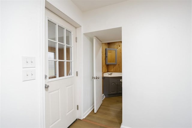 corridor with hardwood / wood-style flooring