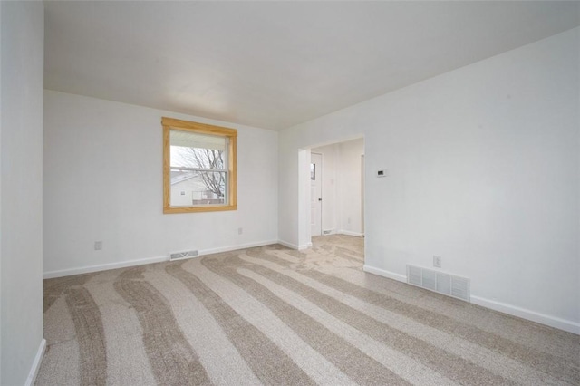 unfurnished room with light carpet