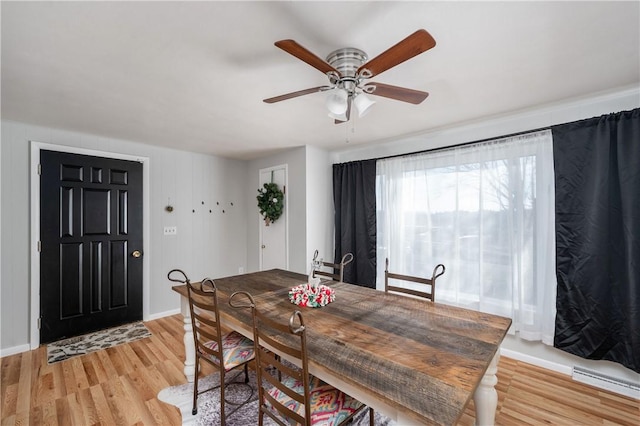 dining space featuring ceiling fan and light wood-type flooring