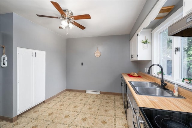 kitchen featuring white cabinets, stove, and sink