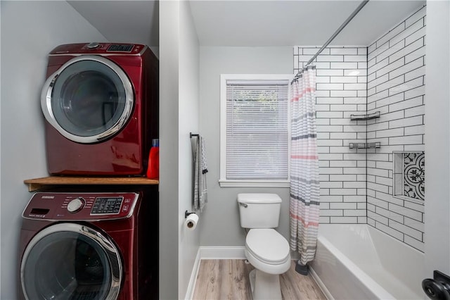 bathroom featuring toilet, wood-type flooring, shower / tub combo with curtain, and stacked washer / dryer