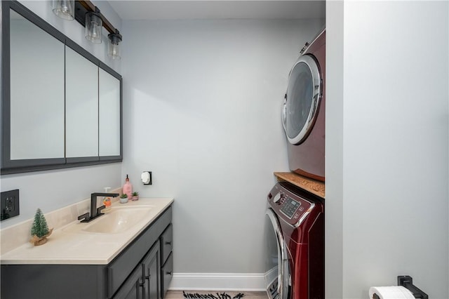 bathroom with vanity, stacked washing maching and dryer, and hardwood / wood-style flooring