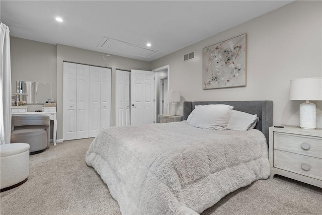 carpeted bedroom with two closets