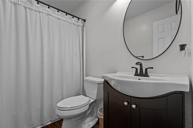 bathroom with hardwood / wood-style floors, vanity, and toilet