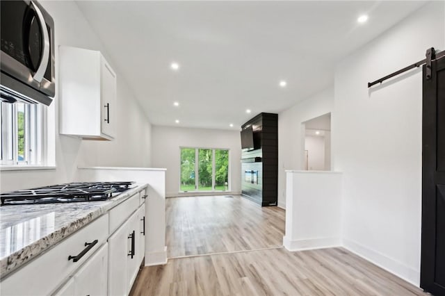 kitchen with white cabinets, a healthy amount of sunlight, and stainless steel appliances