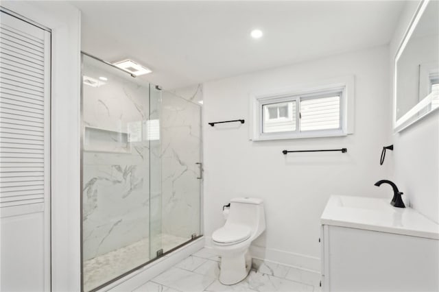 bathroom featuring vanity, toilet, and a shower with door