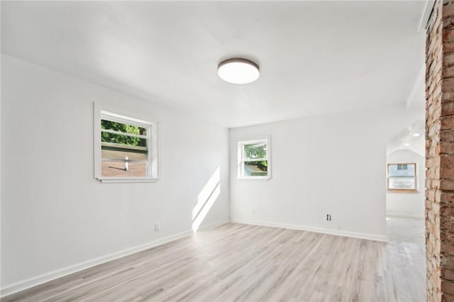 unfurnished living room featuring light hardwood / wood-style floors and lofted ceiling