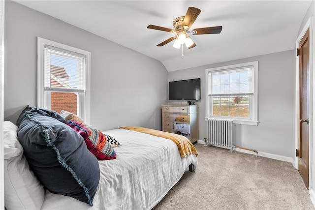 carpeted bedroom featuring multiple windows, radiator, lofted ceiling, and ceiling fan