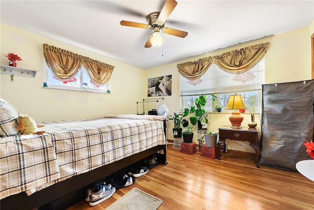 bedroom featuring hardwood / wood-style flooring and ceiling fan